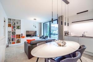 a kitchen and living room with a table and a couch at Luxury apartment in the centre of Ostend with terrace in Ostend