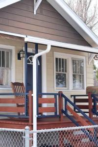 ein Haus mit zwei Holzbänken auf der Veranda in der Unterkunft Wyoming Freedom in Casper