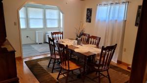 a dining room with a wooden table and chairs at Classic Charm Close To Lake in Canyon Lake