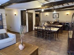 a living room with tables and chairs and a couch at CASA RURAL HORMILLA in Hormilla