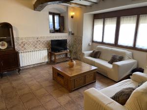 a living room with two couches and a coffee table at CASA RURAL HORMILLA in Hormilla