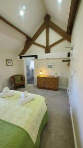a bedroom with two beds and a dresser in it at The Lodge a beautiful barn conversion with 3 ensuite bedrooms on the edge of Cannock Chase in Hednesford