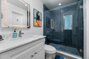 a bathroom with a shower and a toilet and a sink at The Riverside Retreat 2 in Fort Lauderdale +75 photos