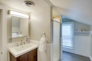 a bathroom with a sink and a mirror at Family-Friendly House Walk to Lake Michigan! in Sheboygan +16 photos