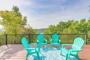 three blue chairs sitting on a deck with a view at A-Frame Hardy Cabin with Spring River Views! in Hardy