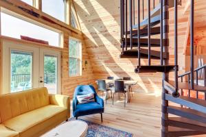 a living room with a couch and a table at A-Frame Hardy Cabin with Spring River Views! in Hardy