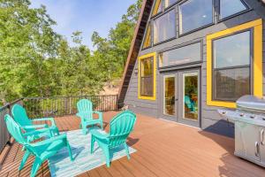 a deck with chairs and a grill on a house at A-Frame Hardy Cabin with Spring River Views! in Hardy