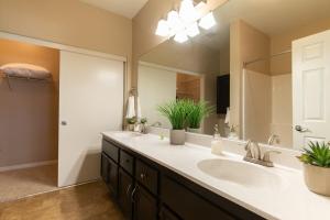 un bagno con due lavandini e un grande specchio di Luxury Suite, Fast Wifi, King Bed, Pool And Spa a Santa Clarita