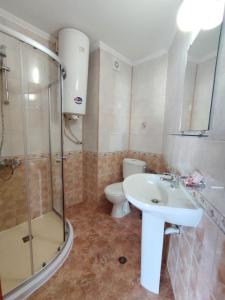 a bathroom with a sink and a shower and a toilet at Vega Village Ap B39 in Sveti Vlas +15 photos
