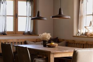 a dining room table with a bowl of flowers and lights at Mountain Residence Bergrichter in Sankt Anton am Arlberg +29 photos