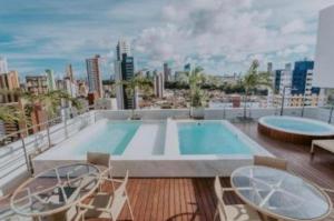 a swimming pool on the roof of a building at Flat 1305 Manaíra Apart Hotel - JP in João Pessoa