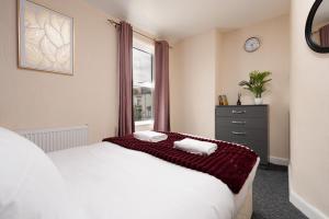 a bedroom with a large white bed and a window at Entire 5 Bedroom home in Birkenhead-Free Parking, Group & Family-Friendly, Free Internet in Birkenhead