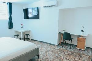 TV a/nebo společenská místnost v ubytování Casa de Playa Hatillo