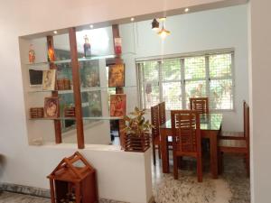 a dining room with a table and chairs at Kanav homestay in Kannur
