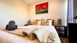 a bedroom with a large white bed with pillows at Seaside Rainbow Retreat At The Pearls #inverter in Summerstrand +33 photos