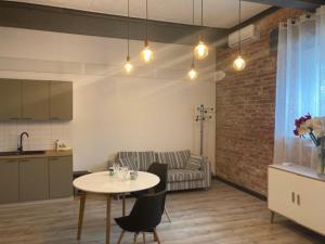 a kitchen and a living room with a table and chairs at Valgeranna Härrastemaja in Audru