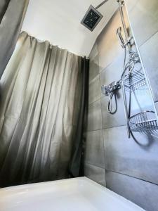 a bathroom with a shower with a shower curtain at Apartment Vanessa in Krk