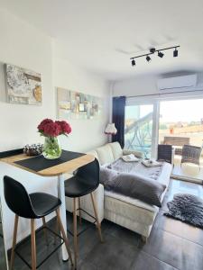 a living room with a table and a couch at Apartment Vanessa in Krk
