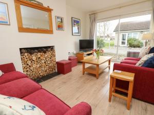 a living room with a red couch and a fire place at Whitfield P7 in Yarmouth