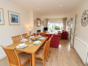 a dining room and living room with a table and chairs at Whitfield P7 in Yarmouth