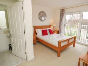 a bedroom with a bed and a large window at Whitfield P7 in Yarmouth