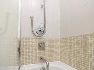 a bathroom with a shower and a tub with a sink at Whitfield P7 in Yarmouth +26 photos