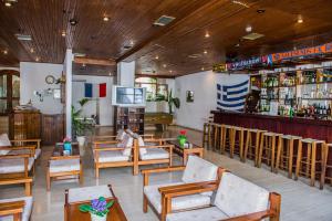 a restaurant with tables and chairs and a bar at Hotel Velissarios in Hersonissos