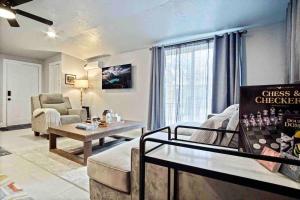 a living room with a couch and a table at Uptown Studio Soaking Tub & Private Yard #04 in Oklahoma City