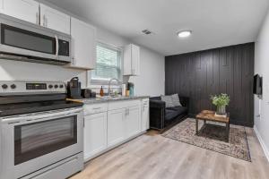 a kitchen with stainless steel appliances and a couch at 2BR Duplex Peaceful Stay 25 Mins to Atlanta in Lithia Springs