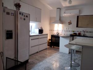 a kitchen with a refrigerator and a table in it at Casa Solis in Balneario Solís