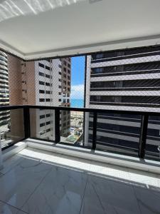 a balcony with a view of a city with tall buildings at Flat Atlântico 405 in Fortaleza