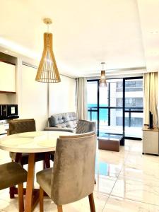 a living room with a table and a couch at Flat Atlântico 405 in Fortaleza