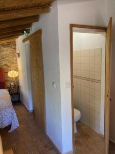 a room with a bathroom with a toilet and a doorway at Quinta Cornélia - Casas Novas in Santa Catarina da Fonte do Bispo