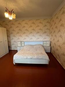 a bedroom with a white bed in a room at Guesthouse in Lankhvri in Mestia