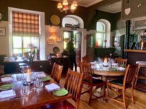 a dining room with tables and chairs in a restaurant at Wild Honey Inn in Lisdoonvarna