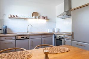 a kitchen with a table and a sink and a stove at Ferienwohnung Bergzeit in Pfronten