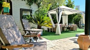 a patio with a gazebo and a table and chairs at Avalena Residence in Zadar