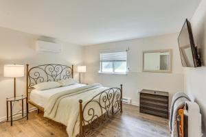 a bedroom with a large bed and a television at 5 Mi to Downtown Harrisburg - Family Home! in Harrisburg