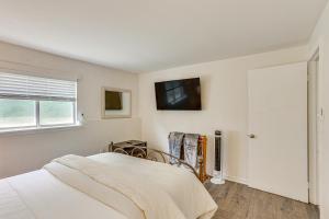 a bedroom with a bed and a tv on the wall at 5 Mi to Downtown Harrisburg - Family Home! in Harrisburg