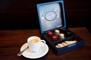 a cup of coffee next to a box of chocolates at Sol Ipanema Hotel in Rio de Janeiro