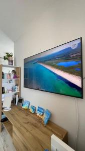 a large flat screen tv hanging on a wall at Studio Kikki Sozopol in Sozopol