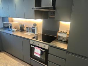 a kitchen with a counter top with a toaster oven at Best rated in Barnsley- apartment sleeps 4 & 5 minute walk to town centre in Barnsley +12 photos