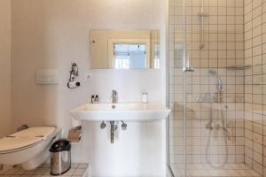 a bathroom with a sink and a toilet and a shower at Warm Cozy Charming 2BD2Bath GalataTower Gem! #256 in Istanbul