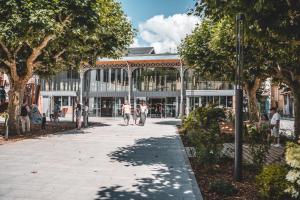 a group of people walking in front of a building at Etoile des Halles Bergerac centre in Bergerac