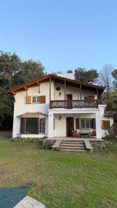 a large white house with a balcony on top at Casa RINCON DEL SOL in Villa la Bolsa
