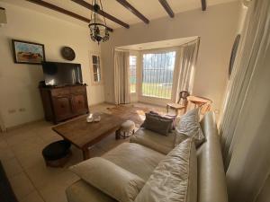 a living room with a couch and a table at Casa RINCON DEL SOL in Villa la Bolsa