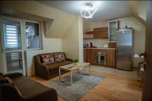 a living room with a couch and a table at Apart Centar in Plovdiv