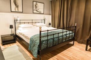 a bedroom with a large bed with a black frame at House Maharac with 3 apartments till 15 persons in Kamno