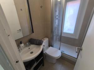 a bathroom with a toilet and a sink and a shower at Imperial Tarraco Apartment in Tarragona +53 photos