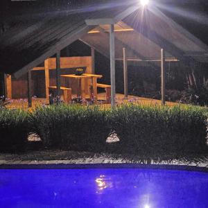 a house with a table and a pool at night at ZUCH Accommodation at Pafuri Self Catering - Guest Apartment in Polokwane +20 photos